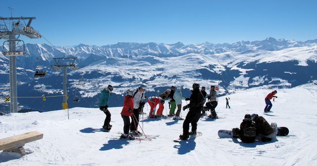 Skiers and Snowboarders in Brigels take in the view